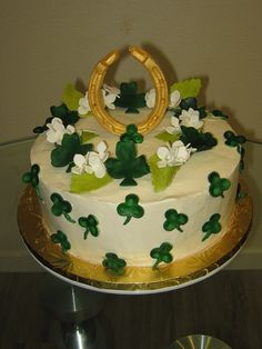 a cake decorated with flowers and leaves on a table