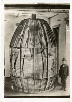 a man standing next to a large woven object