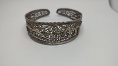 Beautiful antique bracelet made by sterling silver worked in filigree tehnique, no hallmarks, been tested with acid for silver,with time patina In great condition Weight 30grams All of our pieces are in pre-loved, vintage or antique condition, with signs of age and wear preserved as a mark of authenticity. Antique Silver Cuff Bracelet With Oxidized Finish, Unique Antique Silver Cuff Bracelet With Intricate Design, Ornate Hallmarked Sterling Silver Bangle Bracelet, Ornate Hallmarked Sterling Silver Bangle, Antique Oxidized Cuff Bracelet As Gift, Ornate Oxidized Cuff Bracelet Bangle, Antique Oxidized Cuff Bracelet For Gift, Antique Oxidized Finish Cuff Bracelet As Gift, Ornate Oxidized Bangle Cuff Bracelet