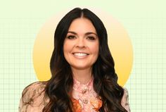 a woman with long dark hair wearing a floral shirt and smiling at the camera, in front of a green background