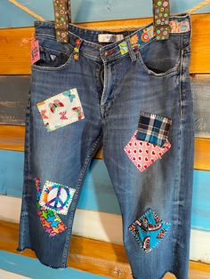 the jeans are decorated with patches and peace signs