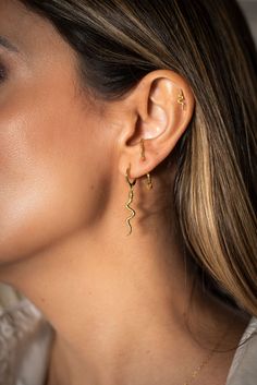 Embrace the trend with our "Hiss" earrings – featuring a small hoop with a dangling snake for a touch of mystique. These earrings capture the allure of serpentine elegance and add a bold statement to your look. The snakes are back, and they're ready to slither into your style with the chic charm of our "Hiss" earrings. 925 Sterling Silver 18k Gold Plated Nickel Free & Hypoallergenic Snake Shape Earrings For Party, Trendy Snake-shaped Earrings For Gifts, Trendy Snake-shaped Jewelry For Parties, Trendy Snake-shaped Party Jewelry, Elegant Snake-shaped Single Earring, Elegant Single Snake-shaped Earring, Adventure Style, Earring Sale, The Trend