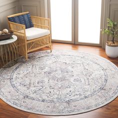 a round rug in the middle of a room with a chair and potted plant