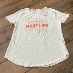 Nwt Orange Theory T-Shirt. Size Medium. White Text Print Crew Neck Top, Sporty White Tops With Text Print, White T-shirt With Logo Print For Everyday, Relaxed Fit White Top With Text Print, White Graphic Tee For Everyday Wear, Basic White Shirt With Text Print, White Sporty Everyday Tops, White Sporty Tops For Everyday, Sporty White T-shirt For Everyday