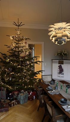 a dining room with a christmas tree in the corner