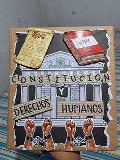 a person holding up a cardboard sign that says construction y defecios and humanos