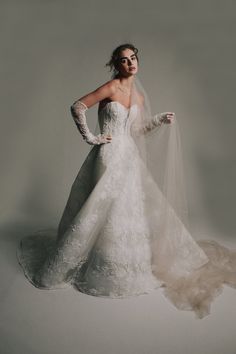 a woman in a white wedding dress and veil