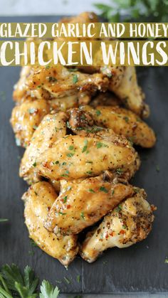 grilled garlic and honey chicken wings on a slate board with parsley garnish