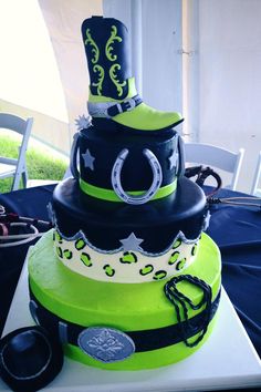 a three tiered cake with black, green and white designs on it's sides