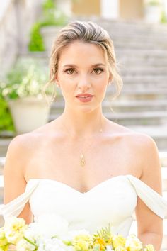 a woman in a wedding dress holding a bouquet