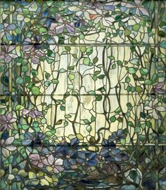 a stained glass window with vines and leaves