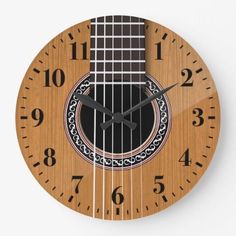 a wooden clock with an acoustic guitar on it's face and numbers around the neck