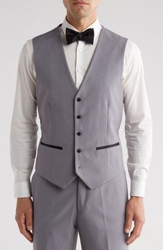 Bring understated elegance to the table in this three-piece tuxedo crafted from rich fabric in a classic single-breasted silhouette. Jacket has shawl collar; chest welt pocket; front welt pockets Vest has front button closure; V-neck Pants have zip fly with button closure; front slant pockets; back button-welt pockets Jacket and vest are lined; trousers are lined to the knee 65% polyester, 35% viscose Dry clean Imported Each suit has a 6” drop, meaning that a size 38R jacket is paired with size Sleeveless Slim Fit Three-piece Suit For Formal Occasions, Sleeveless Slim Fit Three-piece Suit For Formal Events, Classic Fitted Vest For Black Tie Events, Classic Fitted Sleeveless Tuxedo, Formal Fitted Sleeveless Three-piece Suit, Fitted Semi-formal Set With Suit Collar, Fitted Formal Vest With Suit Collar, Fitted Vest With Suit Collar For Formal Events, Fitted Sleeveless Tuxedo Set