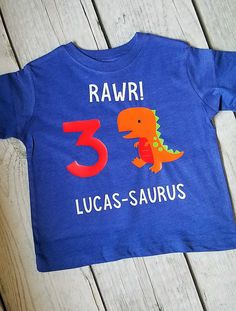 Perfect tee to celebrate your little mans birthday! Made with a white cotton bodysuit or tee shirt and heat transferred vinyl. Number on the shirt can be changed. Just leave a note at checkout. PLEASE LEAVE NAME FOR PERSONALIZATION IN THE NOTES AT CHECKOUT. Sizes Available: Bodysuits available upon request. Message me for color choices. Regular T Shirt Style 12M 18M 2T 3T 4T 5T XS Youth (4-6) S Youth (6-8) M Youth (8-10) L Youth (12-16) Washing Instructions: Wash with like colors. Cold or Warm w Birthday Dinosaur Print Short Sleeve T-shirt, Dinosaur Print Short Sleeve T-shirt For Birthday, Birthday T-shirt With Dinosaur Print, White T-shirt With Dinosaur Print For Birthday, First Birthday T-shirt With Dinosaur Print, Dinosaur Print Short Sleeve T-shirt For First Birthday, Summer Dinosaur Print Top For Birthday, Dinosaur Print Tops For Summer Birthday, Summer Birthday Top With Dinosaur Print