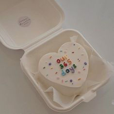 a heart shaped cake in a foam container with sprinkles on the inside