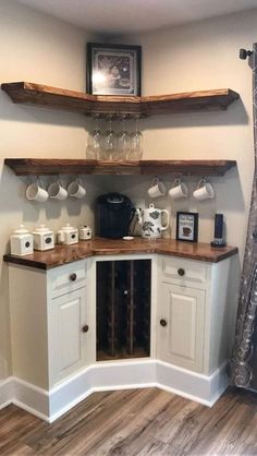 a kitchen with white cabinets and wooden shelves filled with wine glasses on top of them