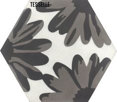 a black and white flower pattern on a hexagonal tile wallpaper with the words tesselle above it