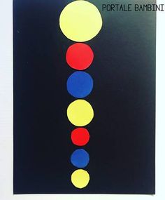 an image of a black background with red, yellow and blue circles