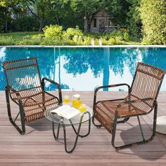 two chairs sitting next to each other near a swimming pool