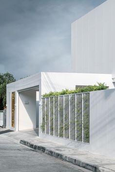 a white building with plants growing on it's side