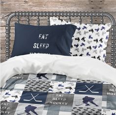 a bed with two pillows on top of it next to a pillow case and blanket