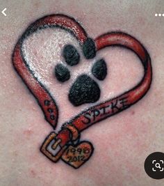 a dog paw and heart tattoo on the back of a woman's chest,