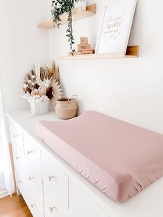 a white dresser with a pink mattress on it