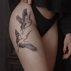 a woman's thigh with two birds on it