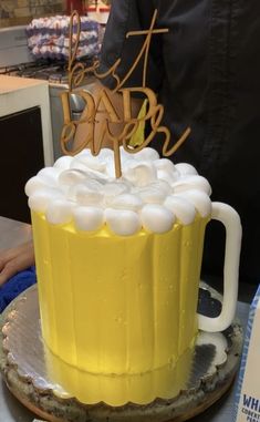 there is a cake that looks like a beer mug with the word happy birthday on it