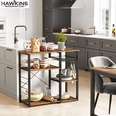 a kitchen with gray cabinets and white walls, an island in the middle has dishes on it