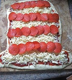 an american flag pizza with pepperoni and cheese on the top is ready to go into the oven