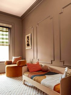 a bed sitting in the middle of a living room next to a chair and window