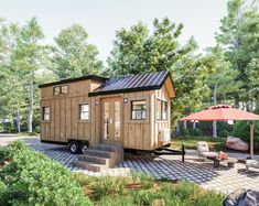 a tiny house is sitting in the middle of a yard with steps leading up to it