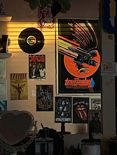 a room filled with lots of different types of records and posters on the wall next to each other