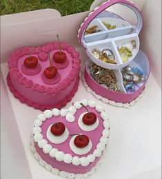 two heart shaped cakes with cherries in the shape of hearts on top of each other