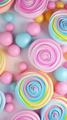 colorful lollipops and balls are scattered on the surface