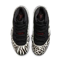 The Nike Women’s Air Jordan 11 Retro 'Animal Instinct' takes Tinker Hatfield's original 1995 design and gives it a wildlife-inspired makeover. The mid-top's signature patent leather overlay is replaced by a furry ivory-colored overlay, finished in a medley of cheetah, leopard and zebra prints in black. The rest of the upper is constructed from black nubuck with tonal webbing lace loops and a raised Jumpman logo on the lateral ankle. Contrasting crimson accents settle on the stylized '23' printed Womens Air Jordan, Tenis Nike Air, Animal Instinct, Jordan Model, Nike Air Jordan 11, Jumpman Logo, Jordans Women, Womens Air Jordans, Air Jordan 11 Retro