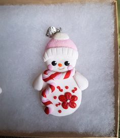 a snowman ornament with a hat and scarf