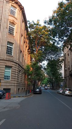 an empty street with cars parked on both sides