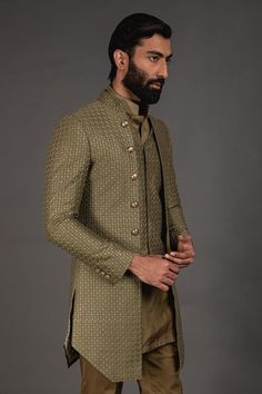 Olive green front open achkan with embroidered detail and full sleeves. Paired with shirt style kurta and lounge pant.
Component: 3
Pattern: Embroidered
Neckline: Mandarin
Sleeve Type: Full Sleeves
Fabric: Chanderi Silk, Cotton Silk
Color: Green
Other Details: 
Silk thread work
Front buttons
Printed lining
Note: Waistcoat worn by the model is not for sale
Occasion: Sangeet - Aza Fashions Semi-formal Long Sleeve Sets For Diwali, Traditional Zari Work Sets For Semi-formal Occasions, Traditional Green Lawn Suit For Formal Occasions, Semi-formal Sets With Resham Embroidery In Traditional Drape, Designer Semi-formal Sets For Diwali, Semi-formal Sets With Resham Embroidery And Traditional Drape, Traditional Green Formal Lawn Suit, Semi-formal Long Sleeve Sets With Resham Embroidery, Green Bandhgala With Dabka Work For Transitional Season