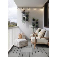 a balcony with two chairs and a couch on the floor next to a planter