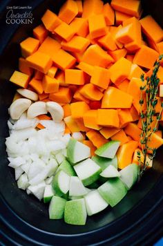 chopped vegetables in a crock pot ready to be cooked