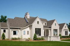 this is an artist's rendering of the front of a house with white brick and gray shingles