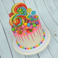 a birthday cake decorated with candies and lollipops