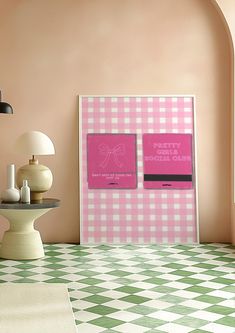 a pink and white checkered floor in a room with two pictures on the wall