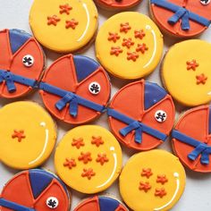 decorated cookies arranged in the shape of pies with bows and crosses on them are displayed