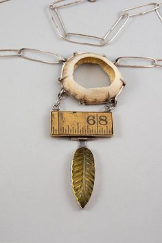 Three seemingly unrelated objects; an amber leaf, a segment of a wooden ruler, and a found shell, are hung together juxtaposing textures, shapes and sizes. While maybe showing similar characteristics. Hand made chain and clasp. Mixed metals and one of a kind. Homemade Jewellery, Jewelry Pictures, Found Object Jewelry, Wooden Ruler, Antler Jewelry, Textile Necklace, Sculptural Jewelry, Mixed Media Jewelry, Alternative Jewelry