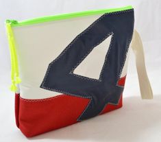 a zippered pouch with a triangle on the front and red, white, and blue lining