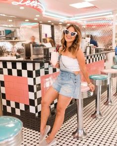 a woman sitting on a stool in a diner