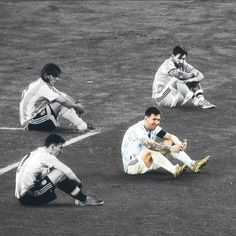 three soccer players sitting on the ground